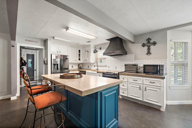 424 Hankamer Loop, Hankamer, TX 77560 - kitchen with stainless steel fridge, black microwave, custom exhaust hood, a textured ceiling, and decorative backsplash