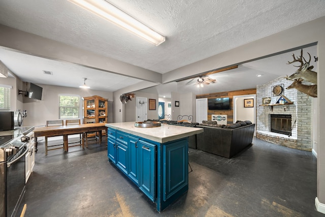 424 Hankamer Loop, Hankamer, TX 77560 - kitchen with blue cabinetry, concrete flooring, electric stove, a textured ceiling, and light countertops