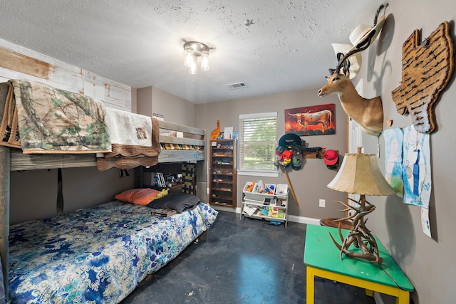 424 Hankamer Loop, Hankamer, TX 77560 - bedroom with a textured ceiling, concrete flooring, and baseboards