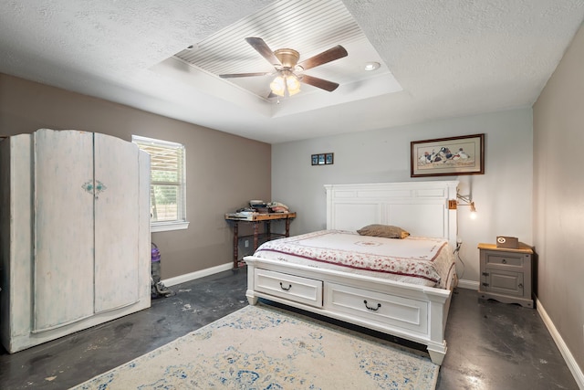 424 Hankamer Loop, Hankamer, TX 77560 - bedroom featuring baseboards, concrete flooring, a raised ceiling, a textured ceiling, and ceiling fan