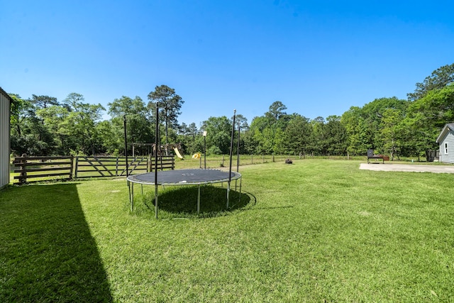 424 Hankamer Loop, Hankamer, TX 77560 - view of yard featuring a trampoline