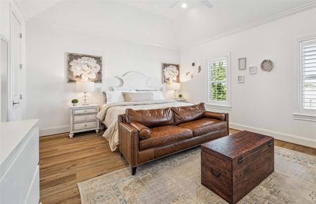 7506 Little Caprese Ln, Houston, TX 77055 - bedroom featuring light wood-type flooring, multiple windows, baseboards, a ceiling fan, and vaulted ceiling