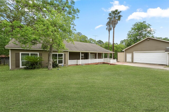 560 Donahoe Rd, Coldspring, TX 77331 - view of front of home with a garage, a front yard, and roof with shingles
