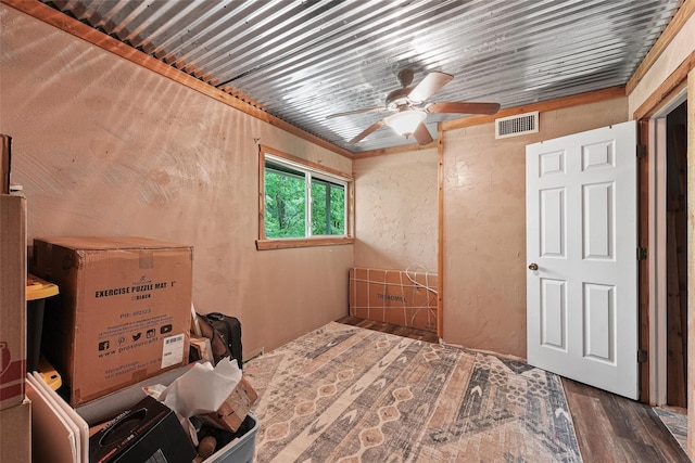 560 Donahoe Rd, Coldspring, TX 77331 - bedroom with wood finished floors, ceiling fan, and a textured wall