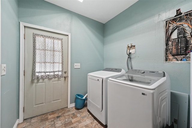 560 Donahoe Rd, Coldspring, TX 77331 - washroom featuring separate washer and dryer, stone finish flooring, and baseboards