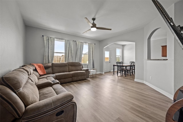 5527 Snapping Turtle Rd, Baytown, TX 77523 - living area with arched walkways, a ceiling fan, light wood-type flooring, and baseboards