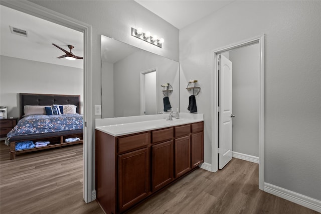 5527 Snapping Turtle Rd, Baytown, TX 77523 - bathroom featuring ensuite bathroom, vanity, wood finished floors, baseboards, and a ceiling fan