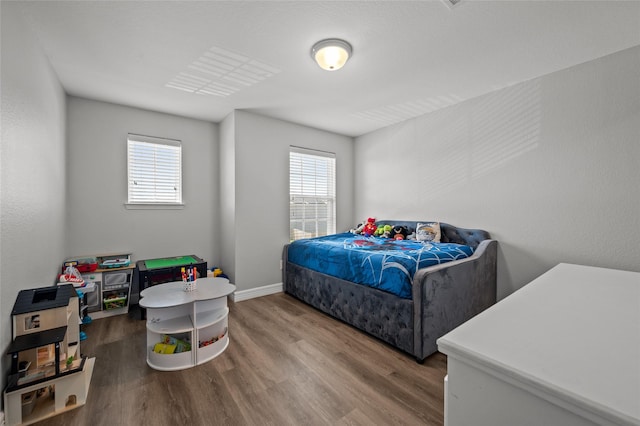 5527 Snapping Turtle Rd, Baytown, TX 77523 - bedroom with wood finished floors and baseboards