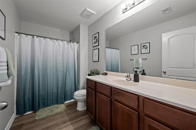 5527 Snapping Turtle Rd, Baytown, TX 77523 - bathroom with wood finished floors, toilet, vanity, and curtained shower