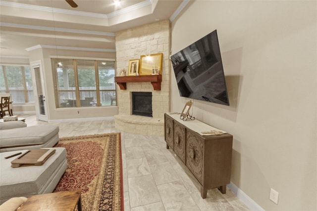 31428 Longwood Park Ln, Spring, TX 77386 - living area featuring crown molding, a raised ceiling, a stone fireplace, a ceiling fan, and baseboards