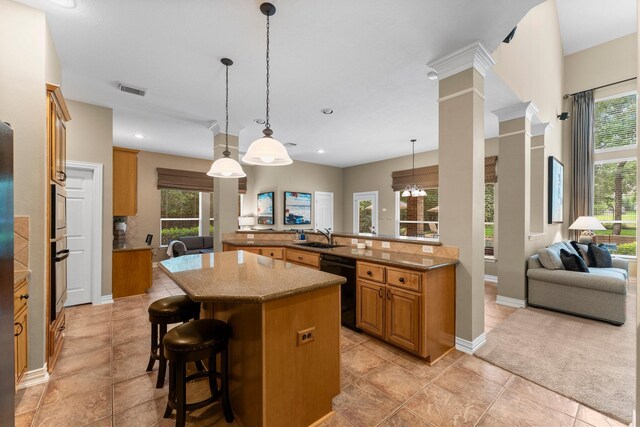 3 Forest Steppes Ct, The Woodlands, TX 77382 - kitchen with dishwasher, brown cabinets, a kitchen bar, a kitchen island, and oven