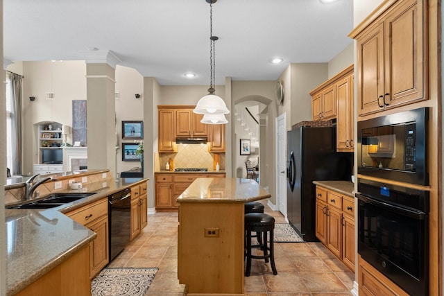 3 Forest Steppes Ct, The Woodlands, TX 77382 - kitchen with black appliances, a sink, a kitchen island, decorative backsplash, and a kitchen breakfast bar