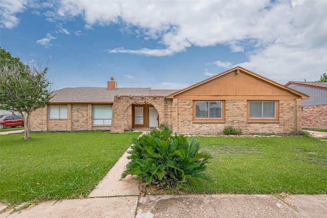 19531 Lazy Valley Dr, Katy, TX 77449 - ranch-style house with brick siding, a front lawn, a chimney, and a shingled roof