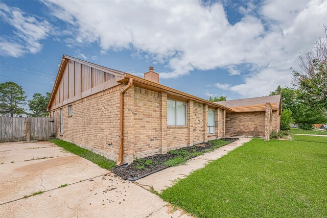 19531 Lazy Valley Dr, Katy, TX 77449 - view of side of property with a chimney, brick siding, and board and batten siding
