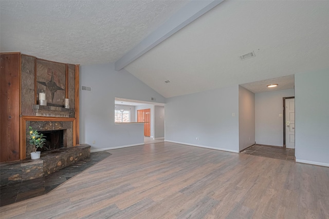 19531 Lazy Valley Dr, Katy, TX 77449 - unfurnished living room with wood finished floors, a tile fireplace, a textured ceiling, and baseboards