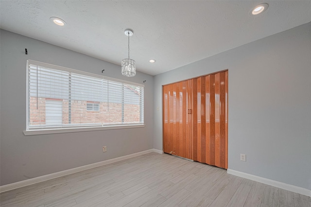 19531 Lazy Valley Dr, Katy, TX 77449 - unfurnished bedroom with wood finished floors, baseboards, a closet, recessed lighting, and a chandelier