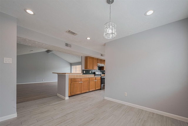 19531 Lazy Valley Dr, Katy, TX 77449 - kitchen featuring stainless steel range with electric cooktop, open floor plan, light wood-type flooring, baseboards, and a textured ceiling