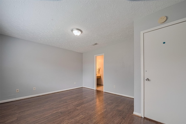 19531 Lazy Valley Dr, Katy, TX 77449 - spare room with dark wood-style floors, a textured ceiling, and baseboards