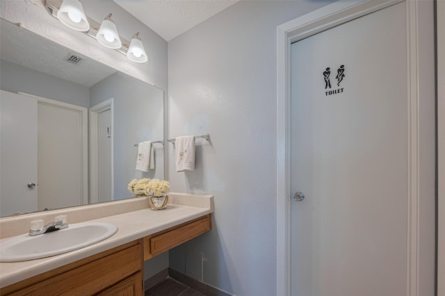 19531 Lazy Valley Dr, Katy, TX 77449 - bathroom featuring vanity, a textured ceiling, and baseboards