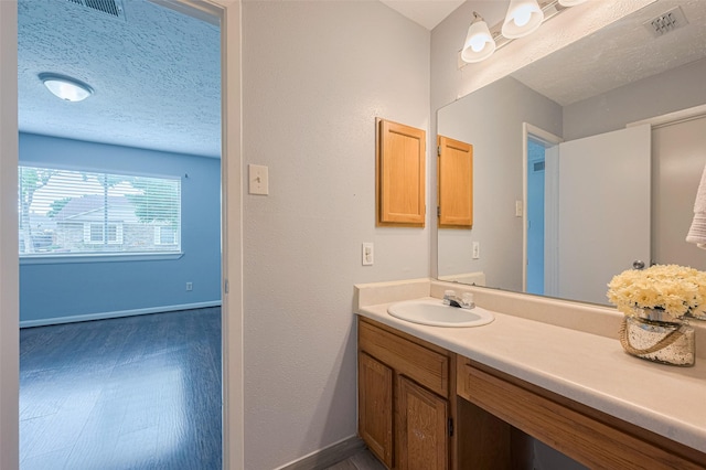 19531 Lazy Valley Dr, Katy, TX 77449 - bathroom with vanity, baseboards, and a textured ceiling