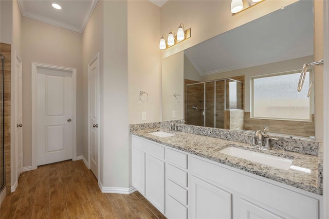 3677 Pinewood Bend Ln, Spring, TX 77386 - full bathroom featuring a shower stall, crown molding, double vanity, baseboards, and wood finished floors