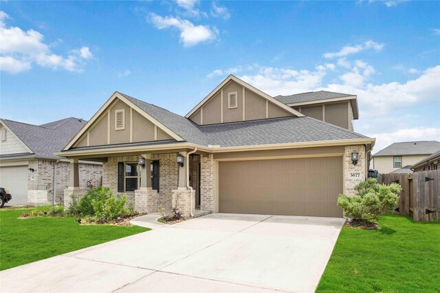 3677 Pinewood Bend Ln, Spring, TX 77386 - view of front of property featuring a garage, stucco siding, concrete driveway, a porch, and brick siding