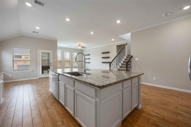 3677 Pinewood Bend Ln, Spring, TX 77386 - kitchen with a sink, light wood finished floors, baseboards, ornamental molding, and a center island with sink