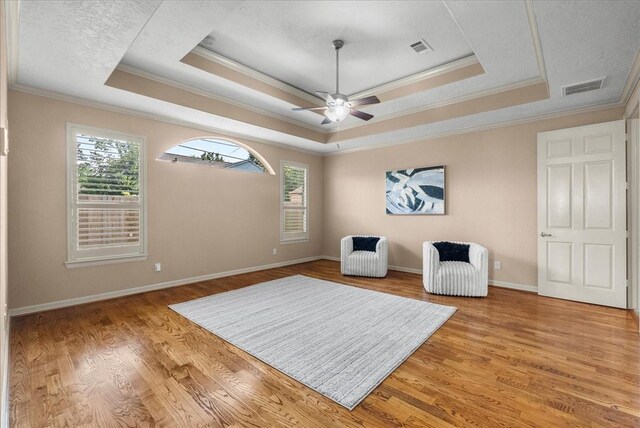3707 Charleston St, Houston, TX 77021 - living area with a raised ceiling, ornamental molding, plenty of natural light, and light wood-style flooring