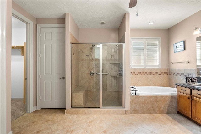 3707 Charleston St, Houston, TX 77021 - bathroom featuring vanity, a stall shower, a garden tub, tile patterned flooring, and a walk in closet
