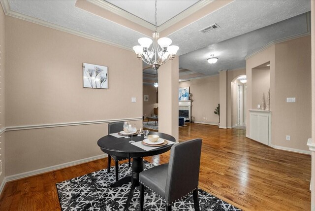 3707 Charleston St, Houston, TX 77021 - dining room featuring crown molding, a tray ceiling, wood finished floors, and baseboards