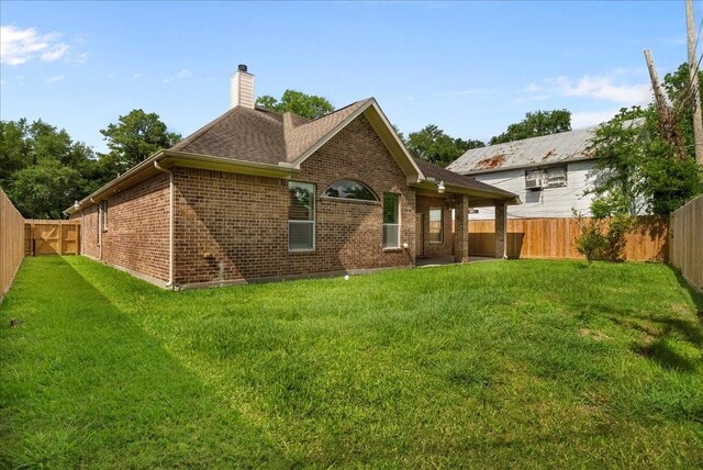 3707 Charleston St, Houston, TX 77021 - rear view of property featuring brick siding, a chimney, and roof with shingles