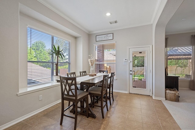 2153 Summit Mist Dr, Conroe, TX 77304 - tiled dining space with crown molding, arched walkways, baseboards, and recessed lighting