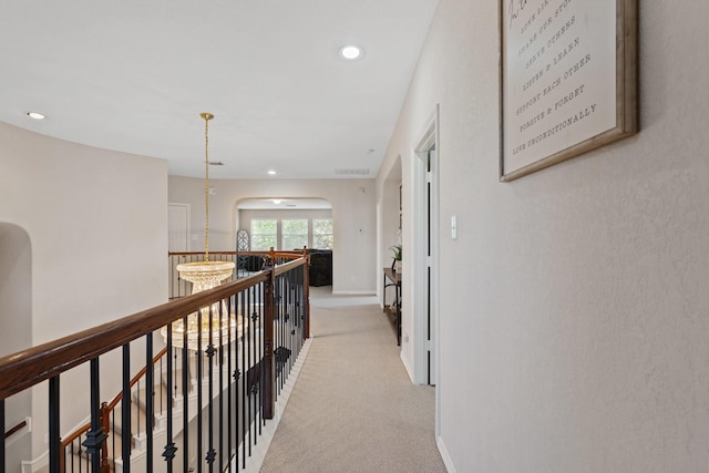 2153 Summit Mist Dr, Conroe, TX 77304 - hallway featuring light colored carpet, recessed lighting, an upstairs landing, baseboards, and arched walkways