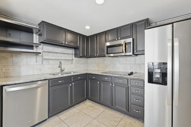 2016 Main St Unit 1502, Houston, TX 77002 - kitchen with appliances with stainless steel finishes, a sink, light tile patterned floors, light stone countertops, and open shelves