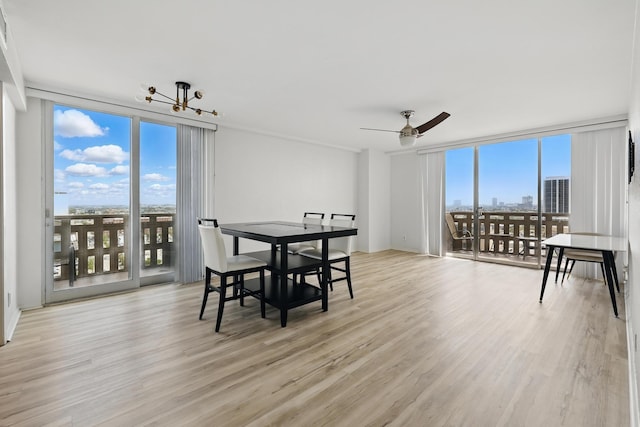 2016 Main St Unit 1502, Houston, TX 77002 - dining area featuring floor to ceiling windows, light wood-style flooring, and a ceiling fan