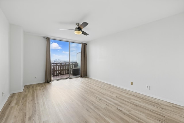 2016 Main St Unit 1502, Houston, TX 77002 - spare room with light wood-style flooring, ceiling fan, floor to ceiling windows, and baseboards