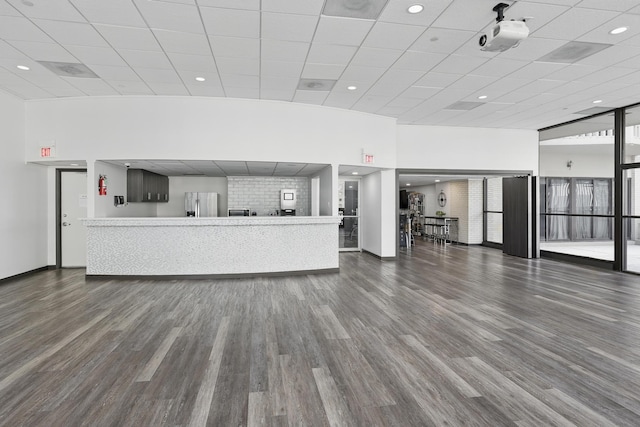 2016 Main St Unit 1502, Houston, TX 77002 - unfurnished living room with wood finished floors, a paneled ceiling, baseboards, plenty of natural light, and recessed lighting