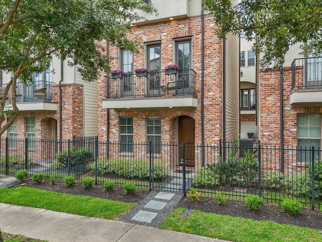 1616 Rosewood St, Houston, TX 77004 - view of front facade with a fenced front yard and brick siding