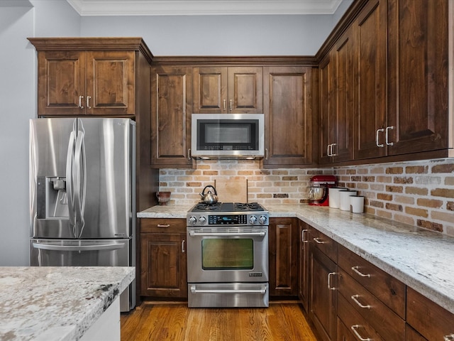 1616 Rosewood St, Houston, TX 77004 - kitchen with stainless steel appliances, backsplash, crown molding, and light wood finished floors