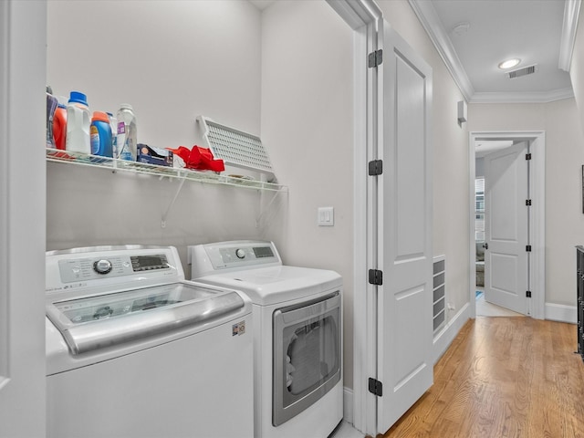 1616 Rosewood St, Houston, TX 77004 - laundry area with independent washer and dryer, crown molding, light wood-style floors, and recessed lighting