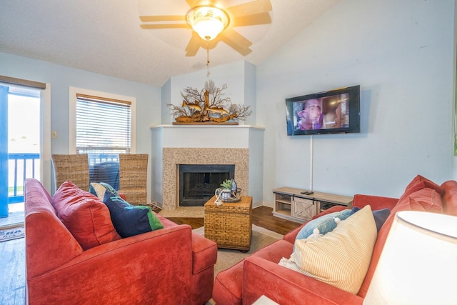 14434 E Cabana St Unit 319, Corpus Christi, TX 78418 - living area with wood finished floors, vaulted ceiling, a fireplace with flush hearth, and a ceiling fan