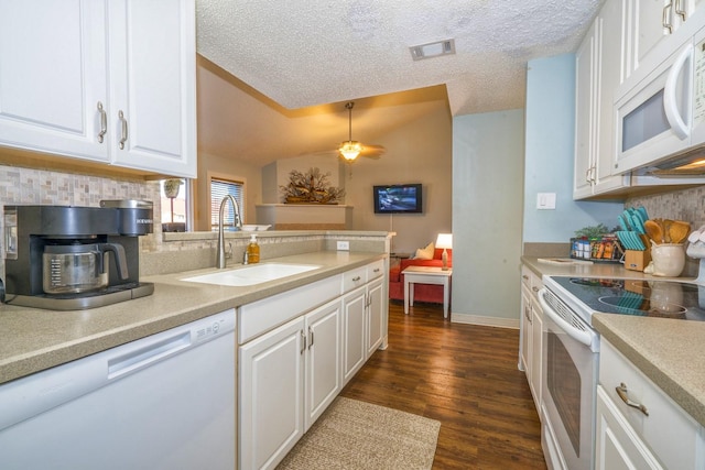 14434 E Cabana St Unit 319, Corpus Christi, TX 78418 - kitchen with white appliances, a sink, backsplash, dark wood-style flooring, and light countertops