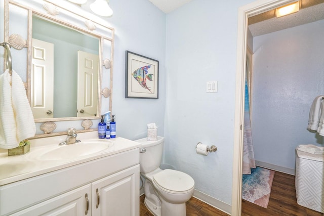 14434 E Cabana St Unit 319, Corpus Christi, TX 78418 - bathroom with vanity, wood finished floors, toilet, and baseboards