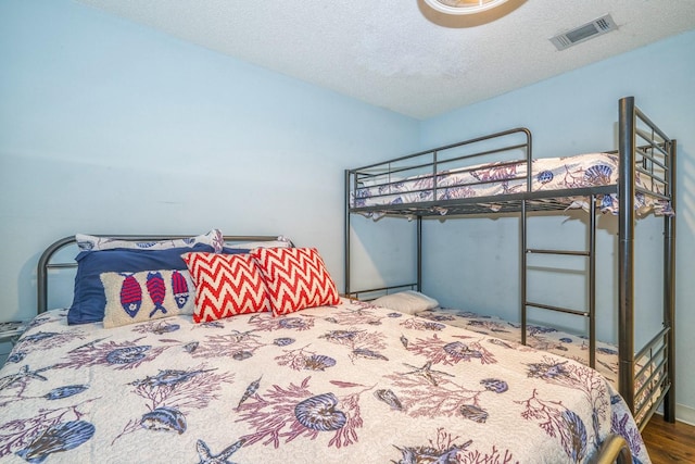 14434 E Cabana St Unit 319, Corpus Christi, TX 78418 - bedroom featuring a textured ceiling and wood finished floors