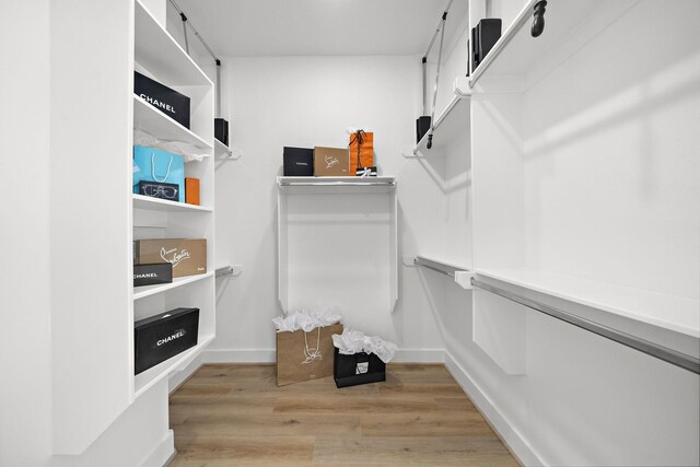 11120 Savannah Woods Ln, Houston, TX 77043 - walk in closet with light wood-style flooring
