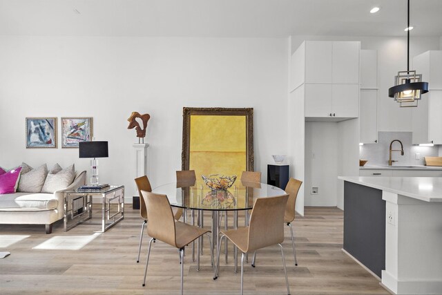 11120 Savannah Woods Ln, Houston, TX 77043 - dining space featuring light wood-type flooring and recessed lighting