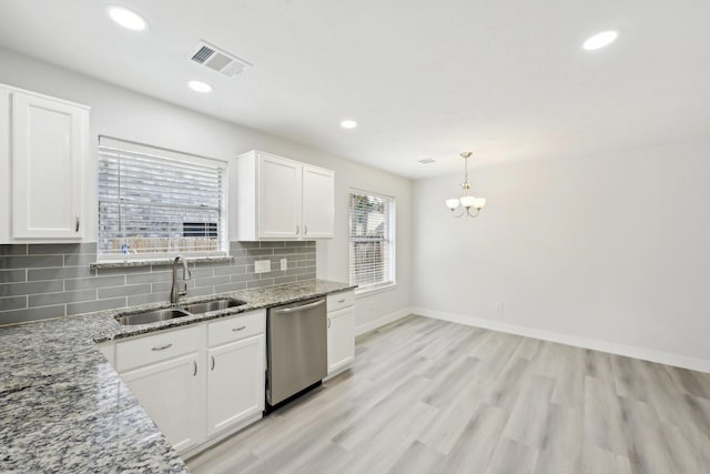 2707 Shawna Lyn Dr, Spring, TX 77373 - kitchen with stainless steel dishwasher, white cabinets, decorative backsplash, light stone counters, and light wood finished floors