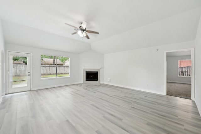 2707 Shawna Lyn Dr, Spring, TX 77373 - unfurnished living room with ceiling fan, a fireplace, light wood finished floors, and vaulted ceiling