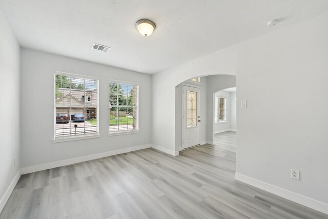 2707 Shawna Lyn Dr, Spring, TX 77373 - empty room with arched walkways and light wood-type flooring