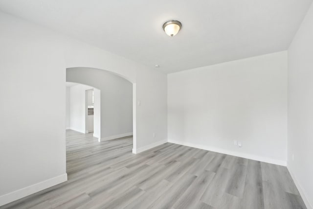 2707 Shawna Lyn Dr, Spring, TX 77373 - spare room featuring arched walkways and light wood finished floors